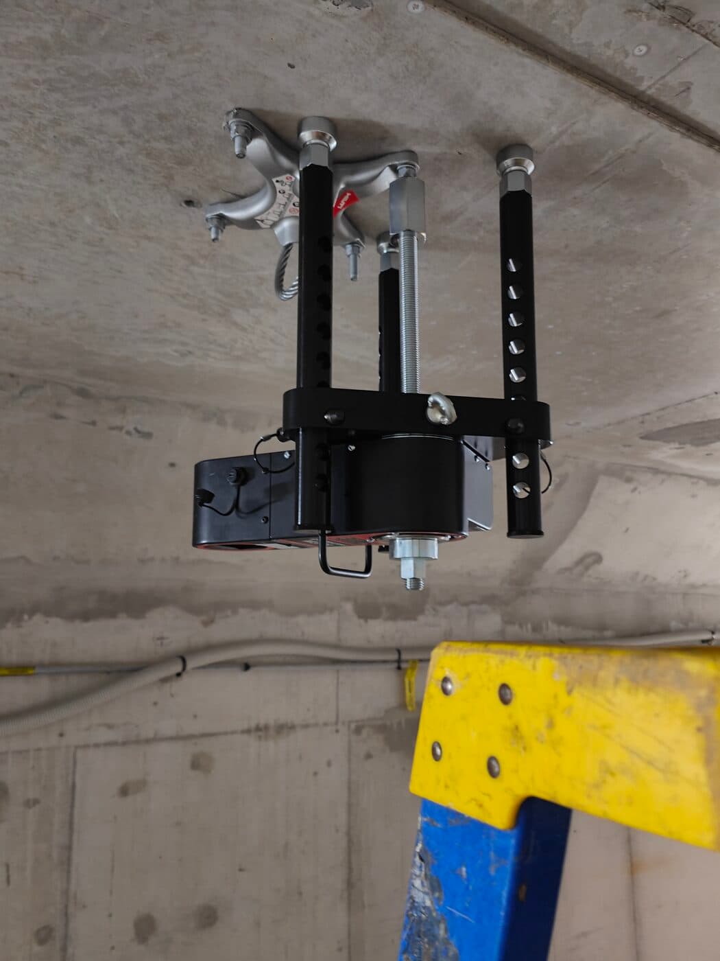 Hydrajaws rig mounted inverted on a concrete soffit for overhead anchor testing - Anchor Testing Australia